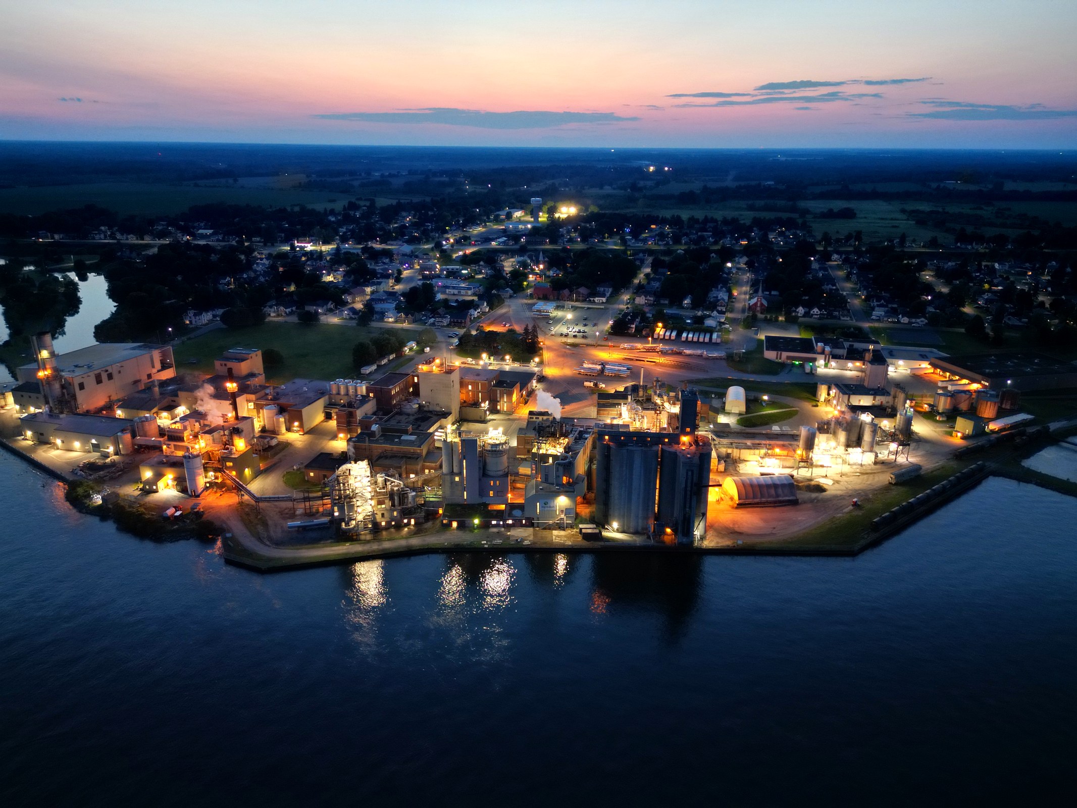 Blue-hour aerial view of an illuminated Eastern Ontario waterfront
