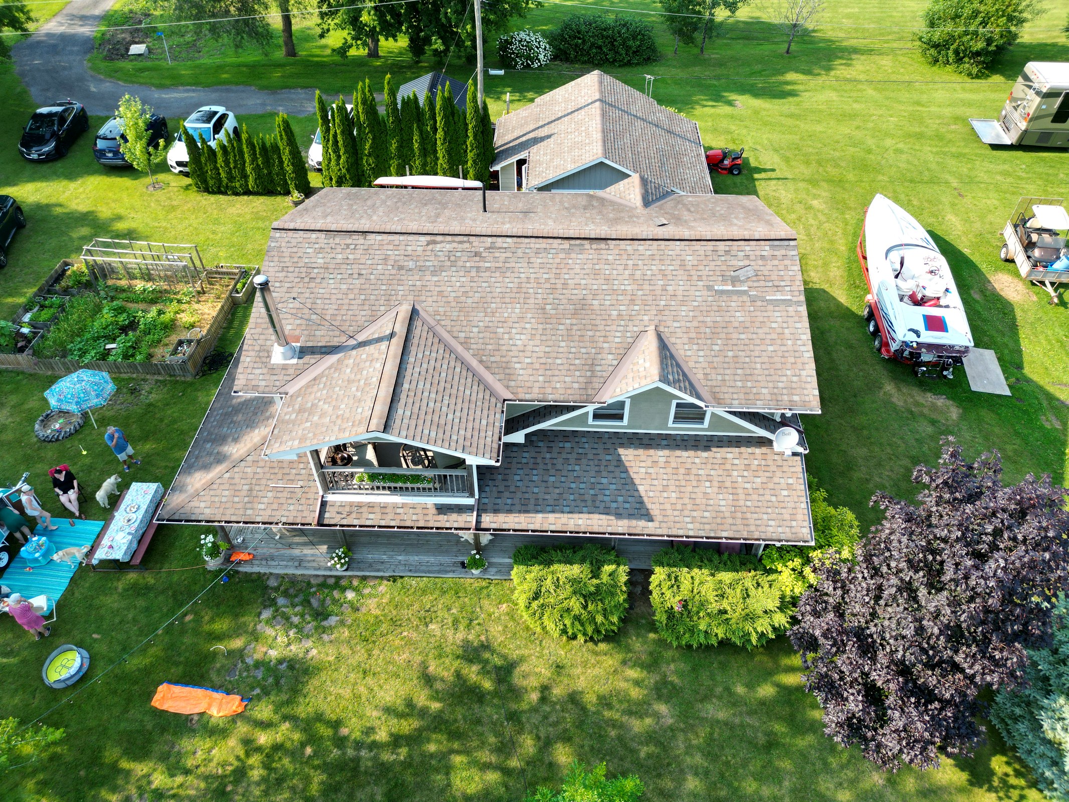 Aerial roof and property overview surrounded by mature trees