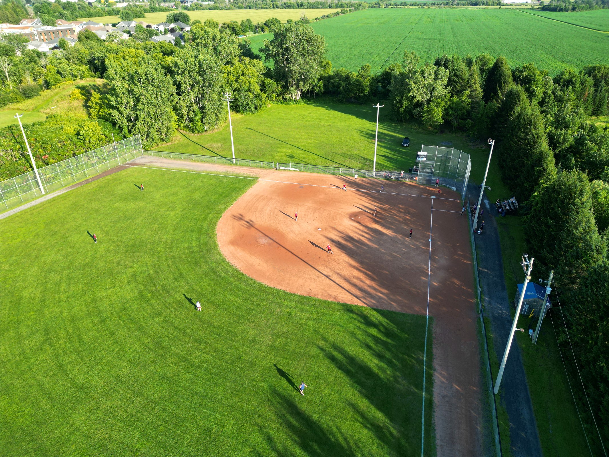 Aerial view of a baseball diamond surrounded by farmland
